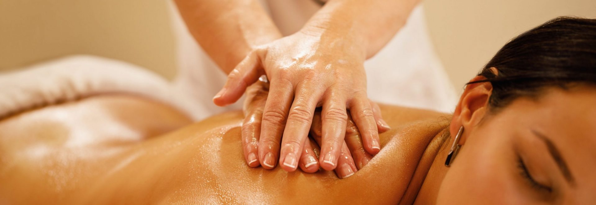 Close-up of woman getting back massage at the spa. Close-up of woman relaxing during back massage at spa salon.